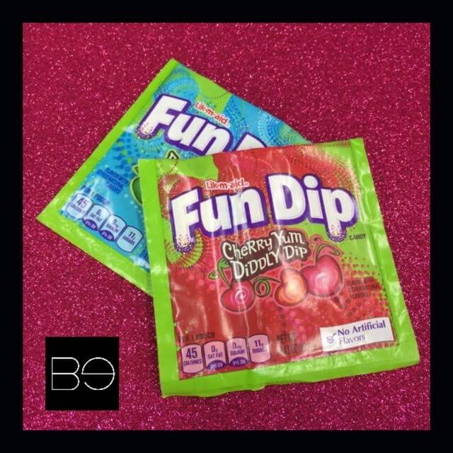 two packets of fun dip candy on a glitter background