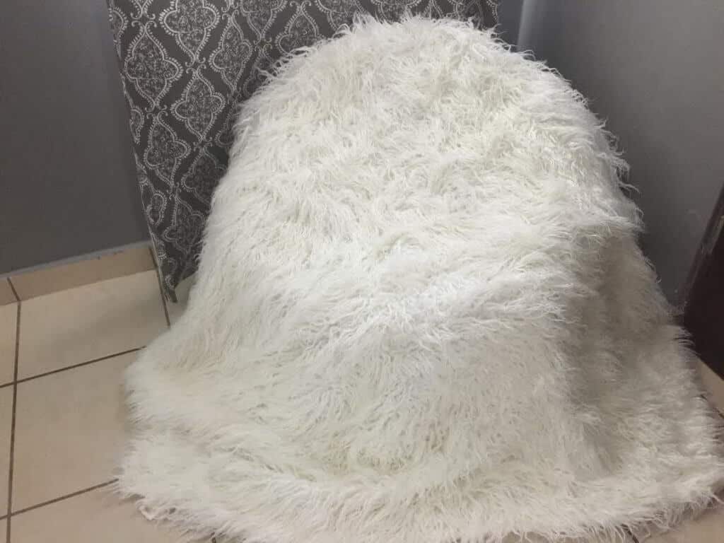 white throw extended over a beanbag