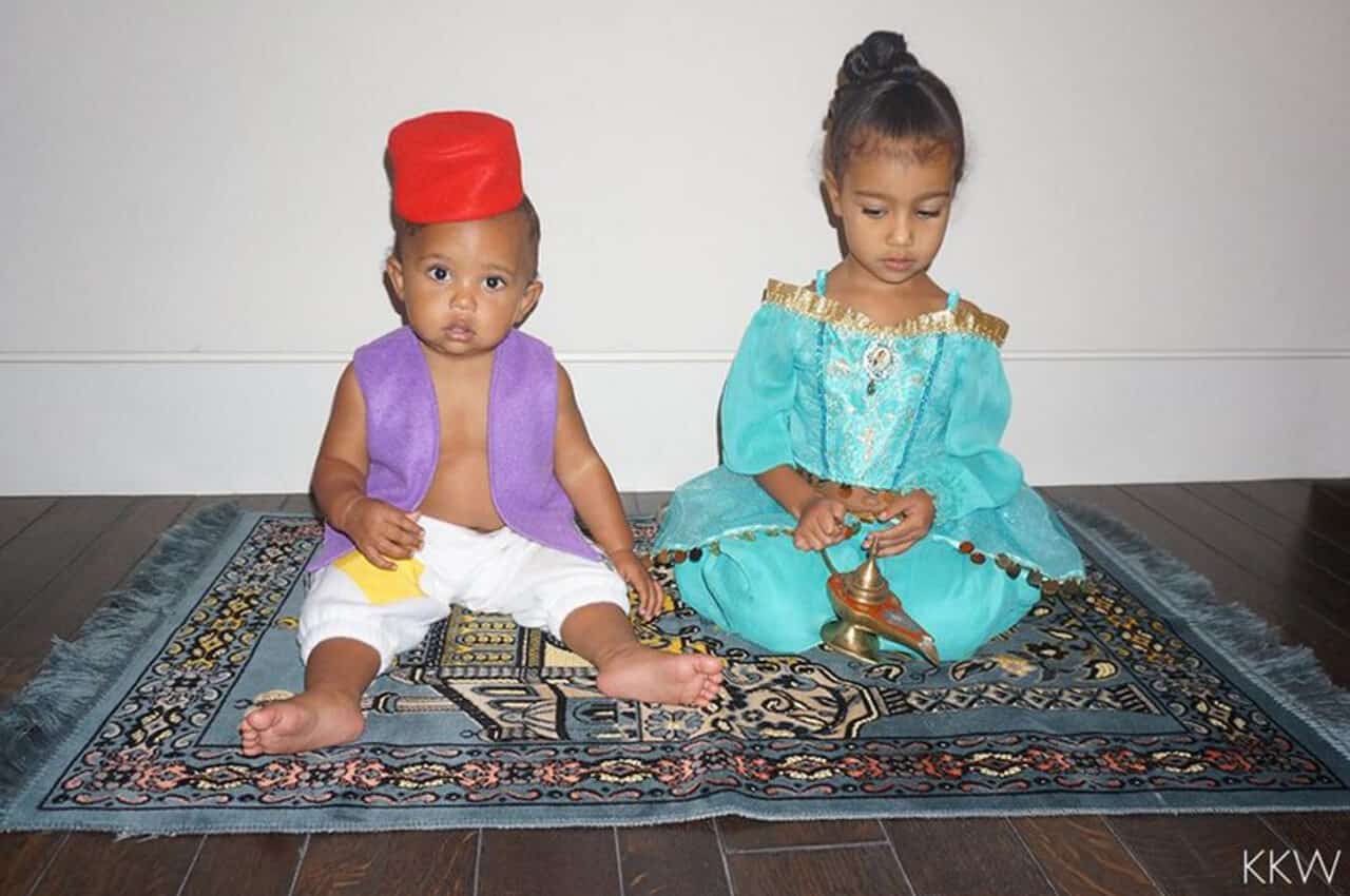 North and Saint West playing together on a run and dressed as Aladdin characters