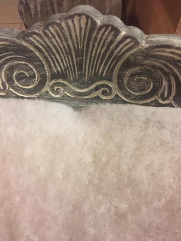 scroll detaiils in the wood of a vintage victorian arm chair