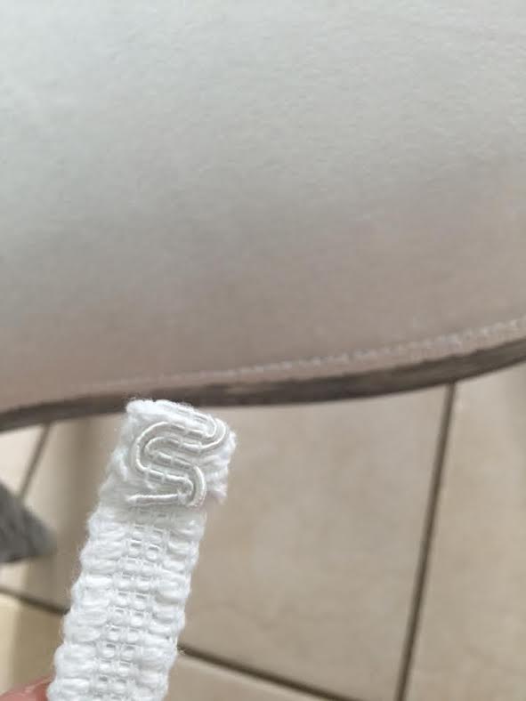white upholstery trim in front of an arm chair