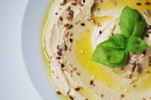 plate with hummus and olive oil