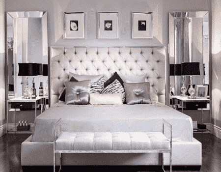 glamorosa habitación con una cama en tonos plateados y mesas de noche en espejo en un post de ideas de decoracion para el cuarto
