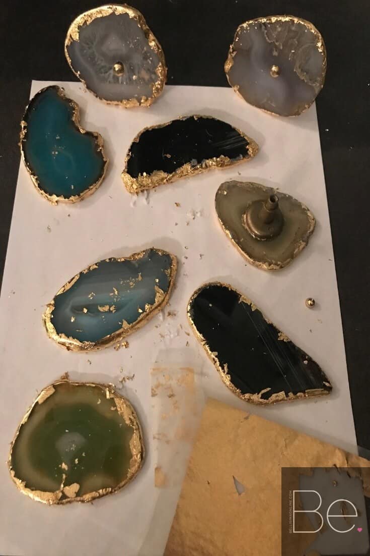 agate slices of different colors being applied gold leaf